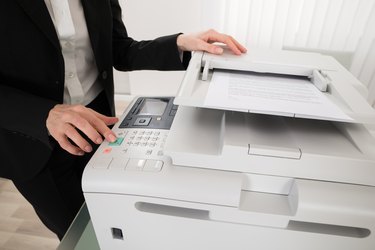 Businesswoman Pressing Printer's Button