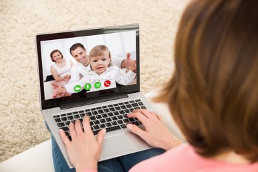 Woman Videochatting With Family On Laptop