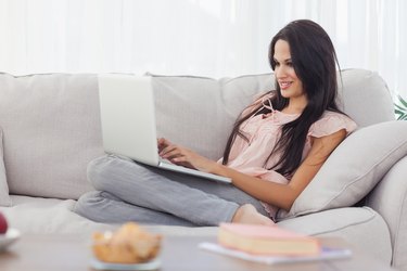 Attractive brunette using her laptop