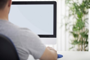 Man in front of computer, back view