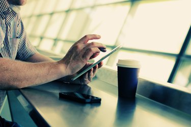 man's hands with tablet