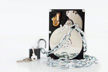 Unlocked padlock near of chained hard disk drive