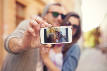 Young couple taking selfie in the city