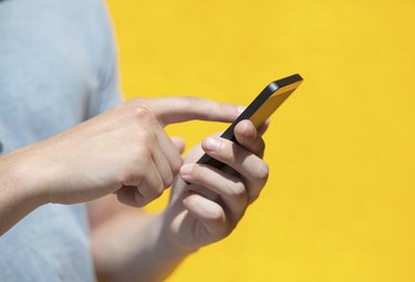 boy holding phone and a touch screen