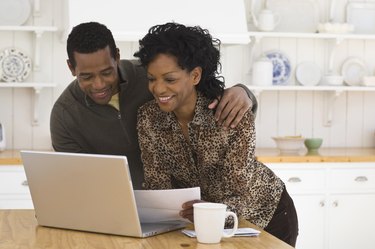 couple doing bills on computer