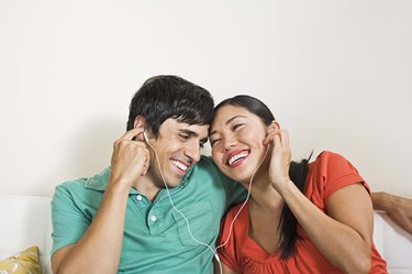 Couple sharing earphones