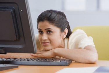 Indian businesswoman looking at laptop