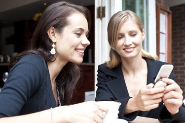 friends using smart phone at coffee shop
