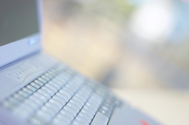 Cropped view of laptop computer outdoors
