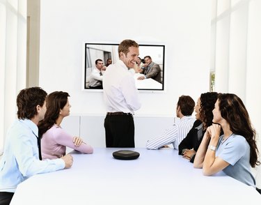 Business Executives in a Meeting with Colleagues via Video Conference