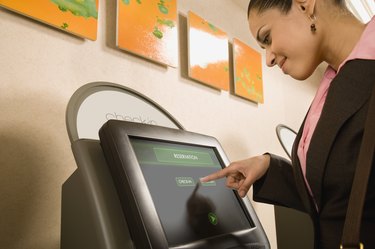 Businesswoman using self check-in terminal