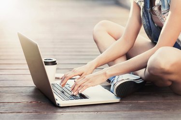 Girl using a laptop outdoors