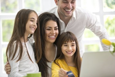 Happy family looking at laptop