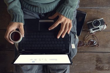 Man hands using Laptop and coffee cup