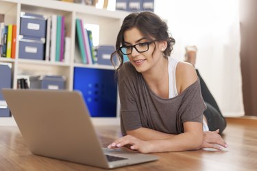 Beautiful woman using digital tablet at home