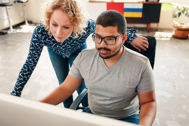 Graphic designers working on computer in office