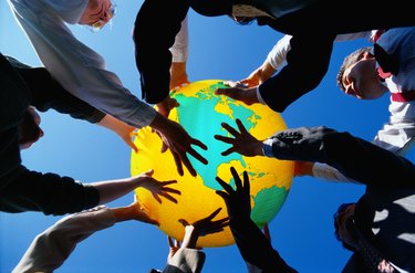 Businesspeople Holding Up a Globe