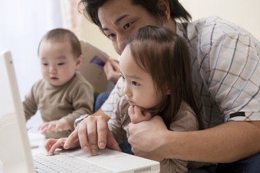 Father and Daughter Looking at PC