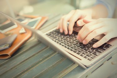 Hands typing on laptop - work anywhere concept (selective focus)