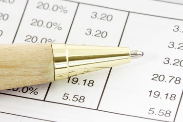 Pen on the financial spreadsheet
