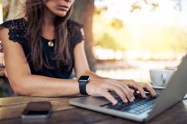 Woman working on laptop in a cafe