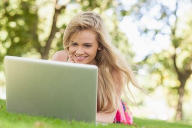 Happy blonde woman working with her notebook