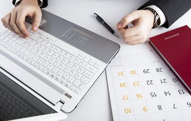 human hands on the notebook keyboard