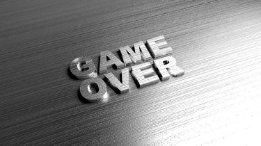 Metal words 'Game over' on metal surface