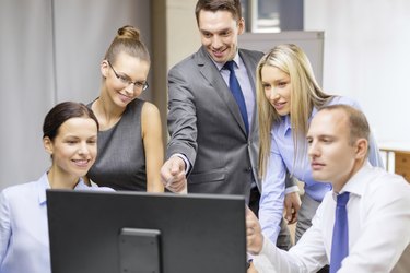 business team with monitor having discussion