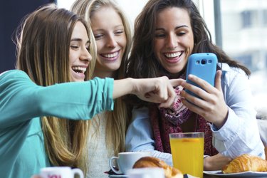 Friends having fun with smartphones