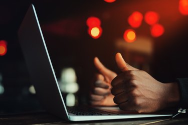 Black man's hands with thumbs up gesture. All is