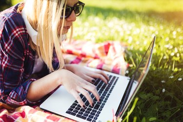 Young female student working on laptop