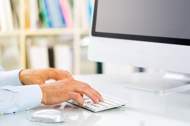 Businessman's Hands Typing on Keyboard