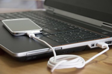 Laptop charging a smartphone