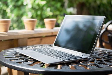 Notebook / Business Tablet With Keyboard Standing On Table Outside