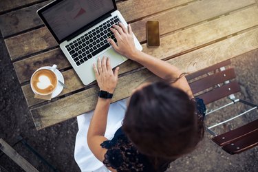 Woman working on her laptop at cafe