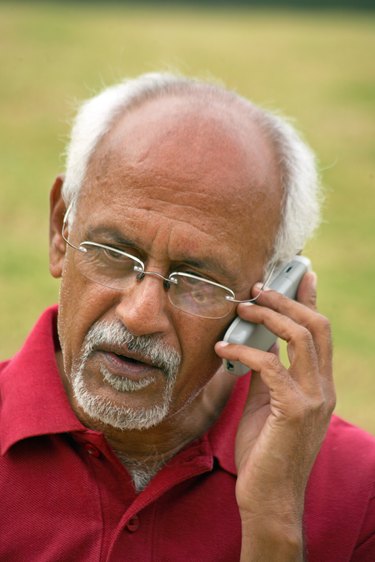 An old man talking on a cell phone