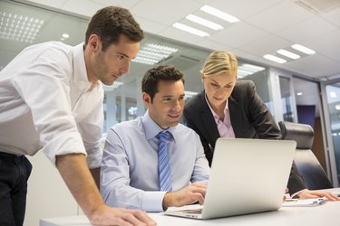 Business team of three in office and planning work