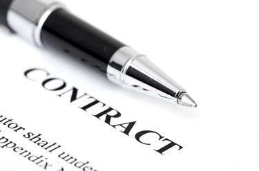 Close-up of silver pen on contract.