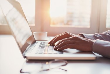 Place of work, man using laptop computer