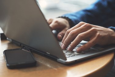 Business mans hands typing on laptop