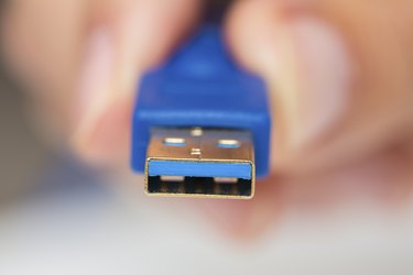 Man's hand holds cable