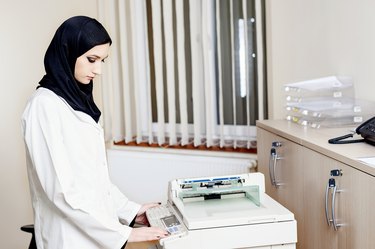 Muslim female doctor makes copies