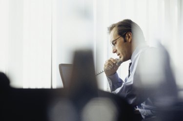 Businessman using phone in office