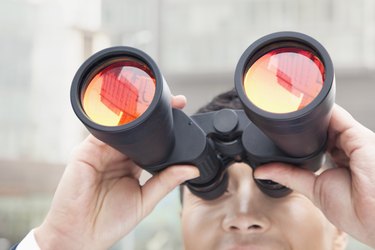 Close Up of Businessman Using Binoculars, Reflection