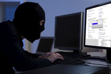 Hacker downloading information off a computer