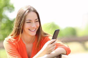 Girl using a smart phone in summer