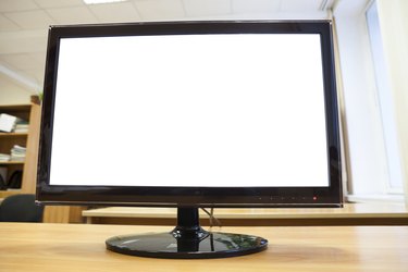 Black monitor with isolated screen standing on an office desk