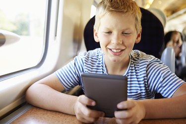 Boy Reading E Book On Train Journey