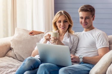 Beautiful young couple with gadget